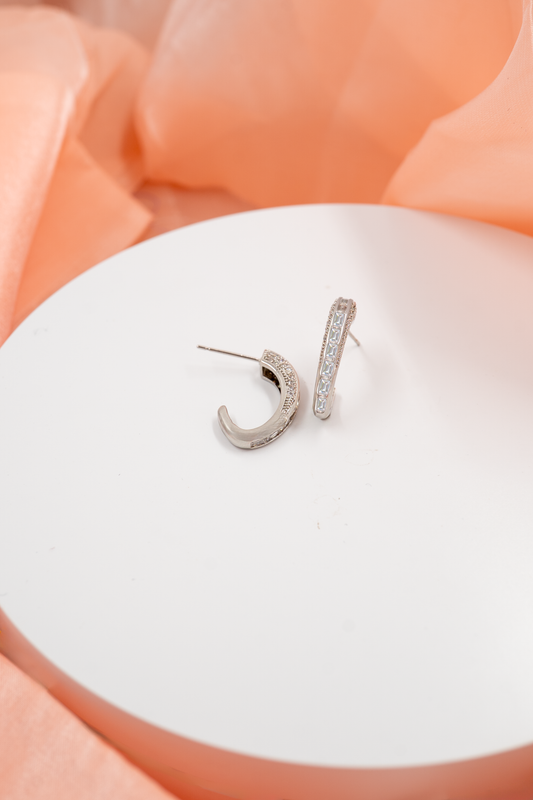Chic and contemporary, the Crystal Curve Hoop Earrings blend minimalist design with radiant sparkle. Adorned with a row of glimmering crystals, these half-hoop studs add a refined elegance to both everyday wear and special occasions.